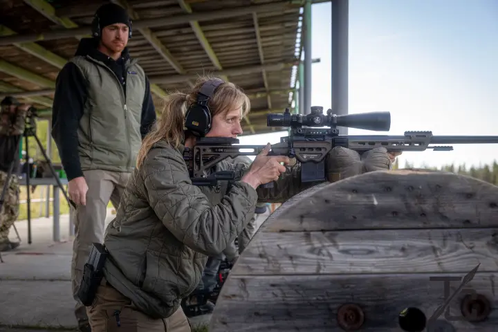 Coaching a woman behind a barricade rest