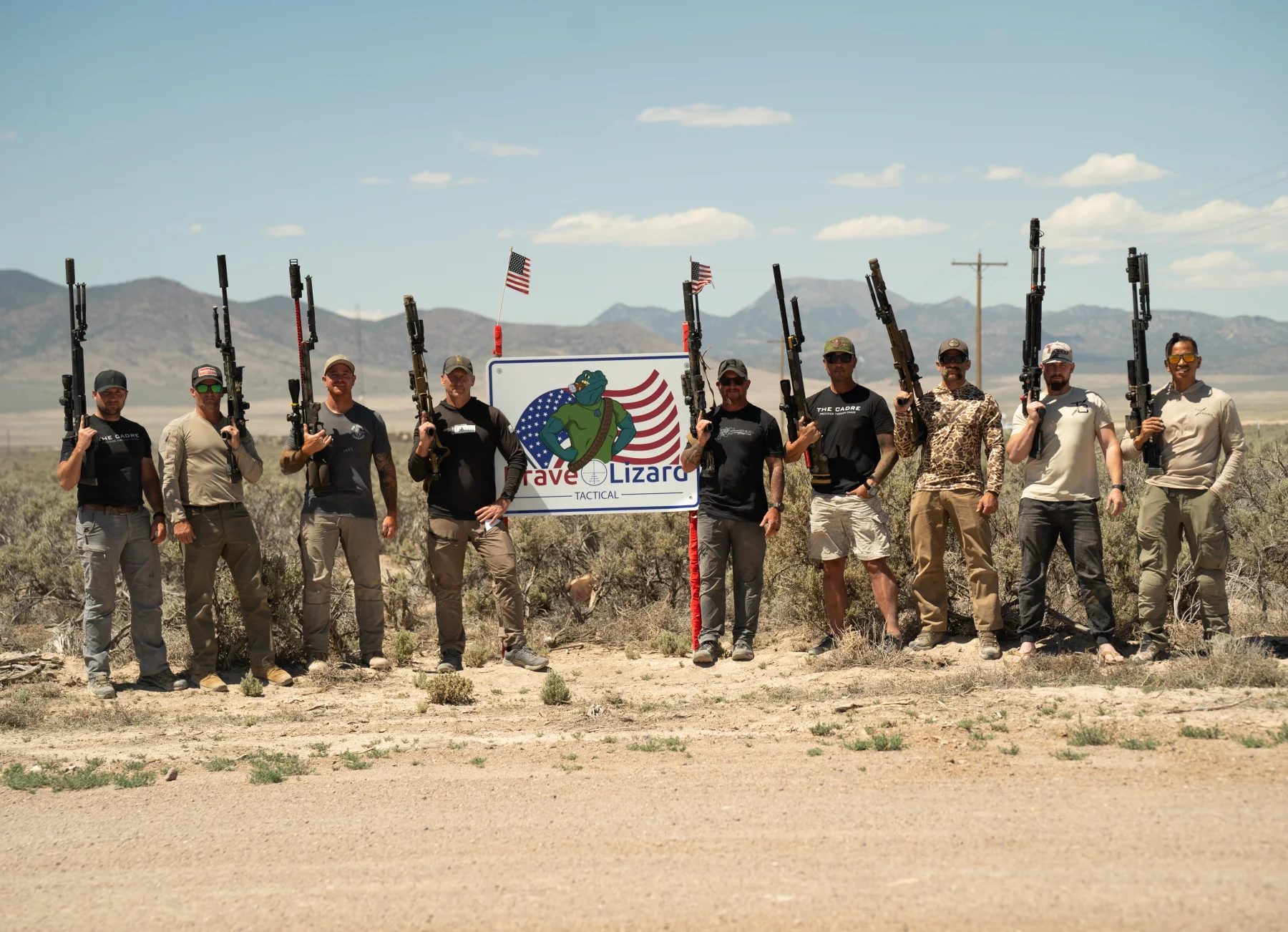 The Invite 2026 group holding rifles on the range