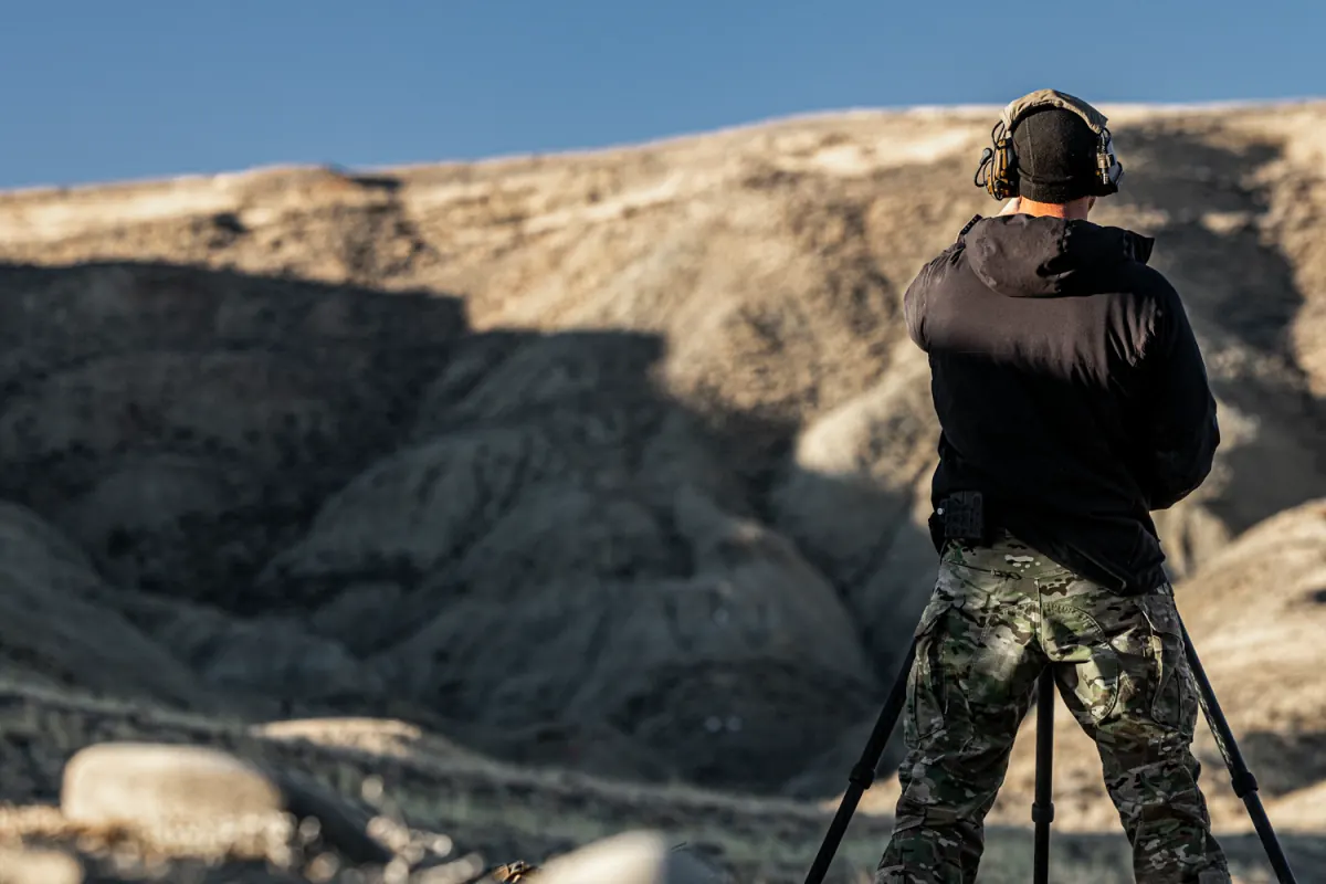 A shooter on a tripod faces the badlands at The Invite in Cody, Wyoming