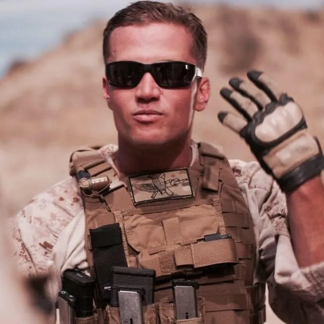 A young Eric Avvisato in desert utilities and a plate carrier with a Recon insignia