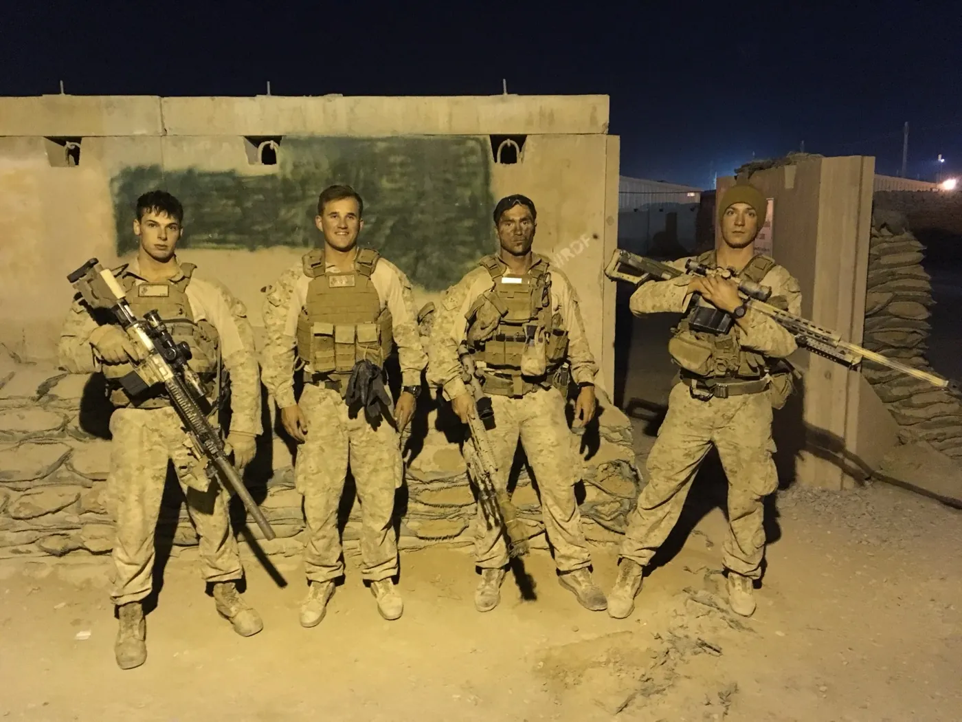 Ian Miner and his Scout Sniper team standing armed at a forward position on deployment
