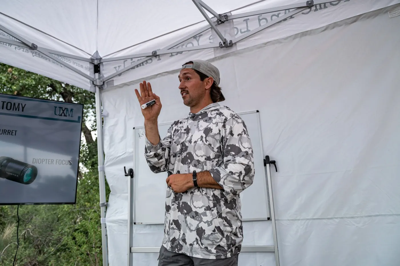 Ian Miner teaching scope anatomy to a class under a range shelter