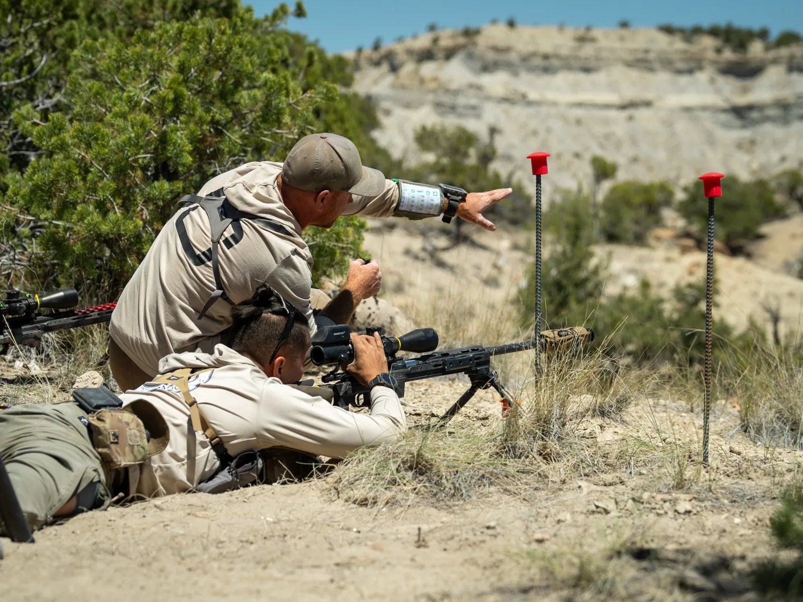 Jon Bumpus spotting and calling a target downrange while his teammate shoots prone at an NRL Hunter match