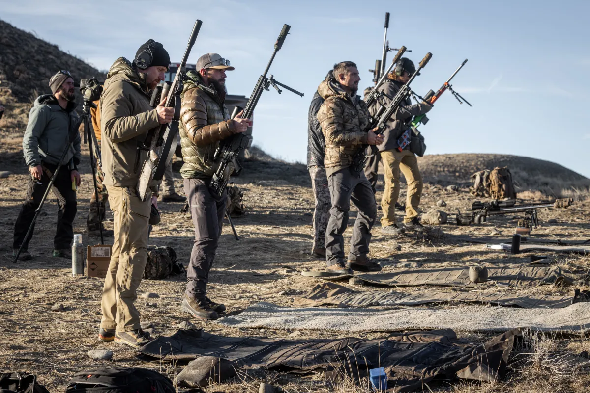 Shooters carrying precision rifles on the range at The Invite 2024